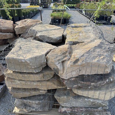 Stacked boulders in wire basket